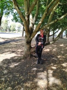 Contact Eric for Voice Over - in the park with a friend with me leaning against a tree.